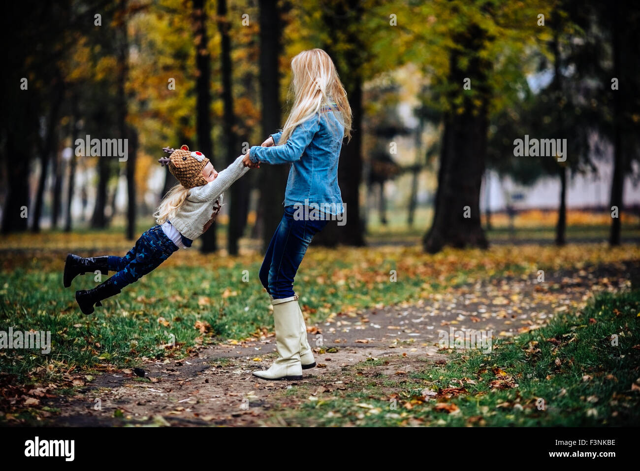 Mother with daughter in autumn park Stock Photo - Alamy
