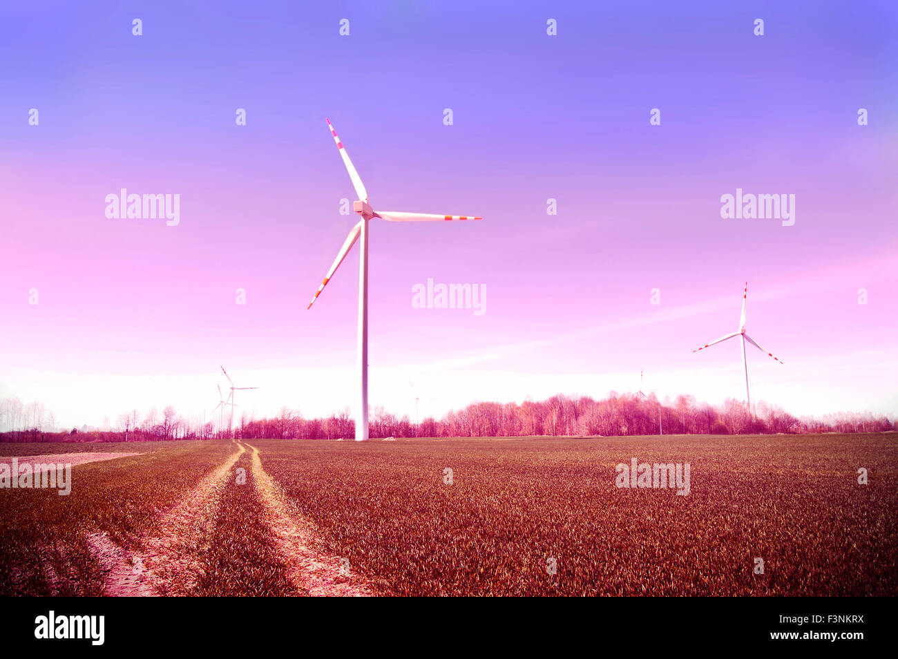 Windmills on the field. Vintage instagram picture. Alternative energy. Stock Photo