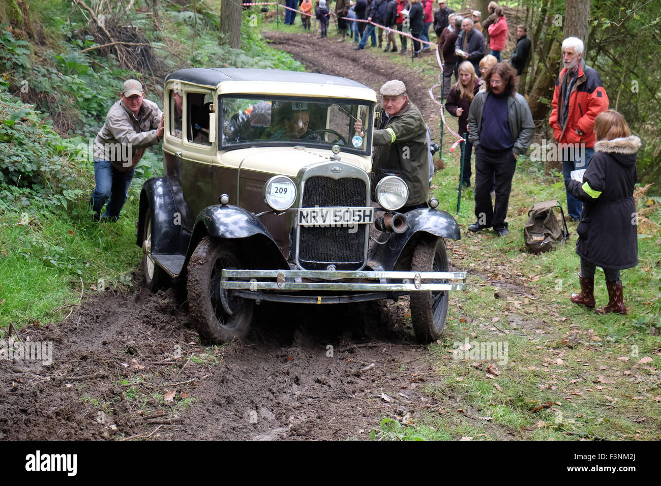 New Radnor, Powys, Wales - Saturday 10th October 2015 - The Vintage Sports Car Club ( VSCC ) hill climb trial challenge on The Smatcher a steep wooded hill just outside New Radnor. Competitors score points the further they drive up the steep hill with 25 points being awarded for reaching the top. Shown here is a 1930 Ford Model 'A' struggling on the muddy climb. News Stock Photo
