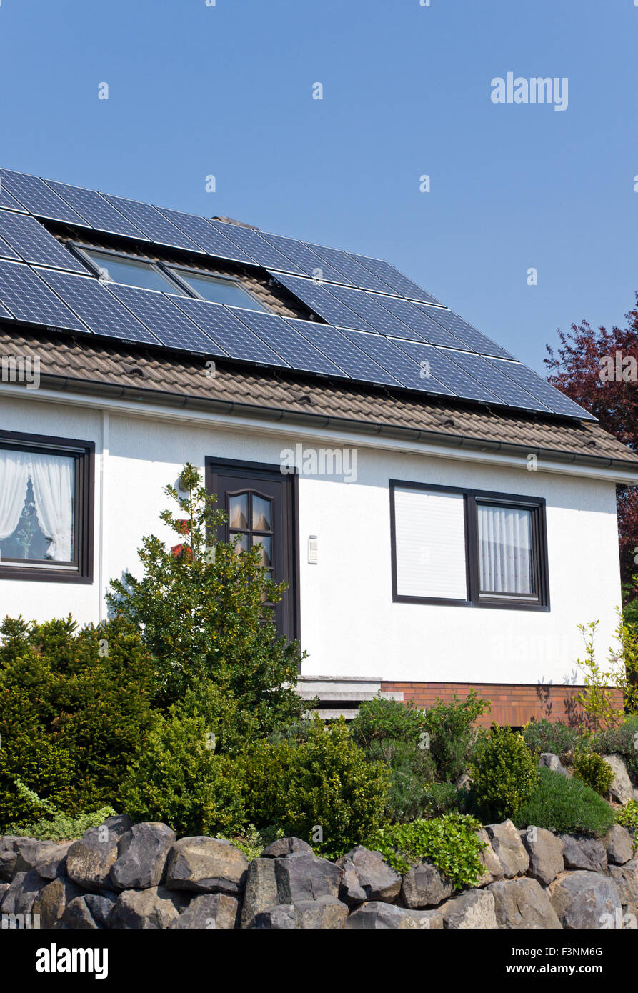 Solar panels on the roof of a single occupancy house Stock Photo