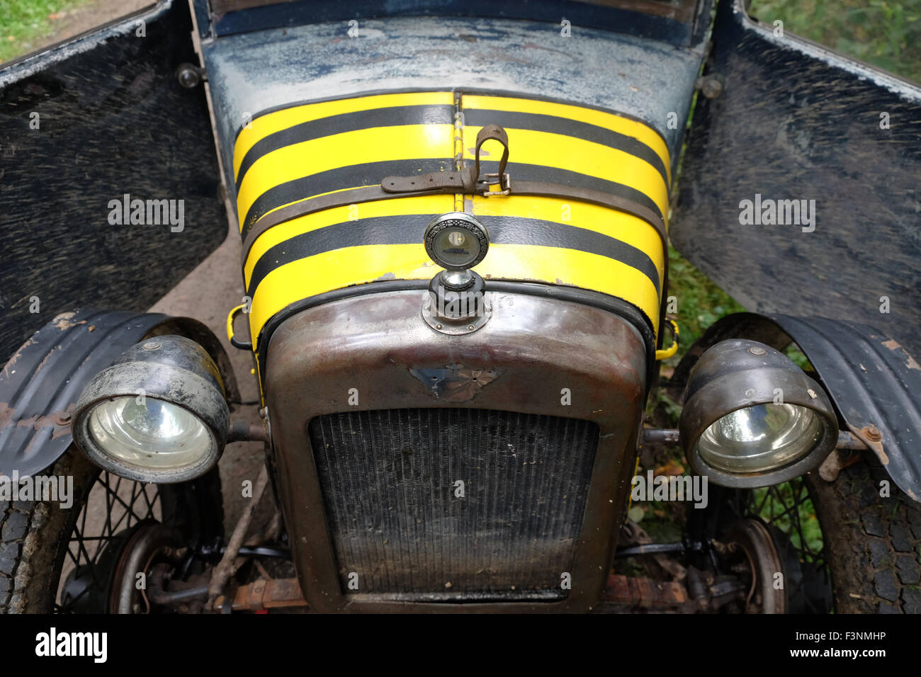 New Radnor, Powys, Wales - Saturday 10th October 2015 - The Vintage Sports Car Club ( VSCC ) hill climb trial challenge on The Smatcher a steep wooded hill just outside New Radnor. Shown here is a muddy 1929 Austin 7 Saloon with forward opening doors. Stock Photo