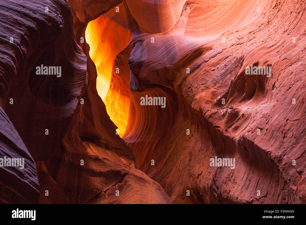 Colorful ancient sandstone walls eroded by time and water to create smooth layers in Canyon X in Page, Arizona. Stock Photo