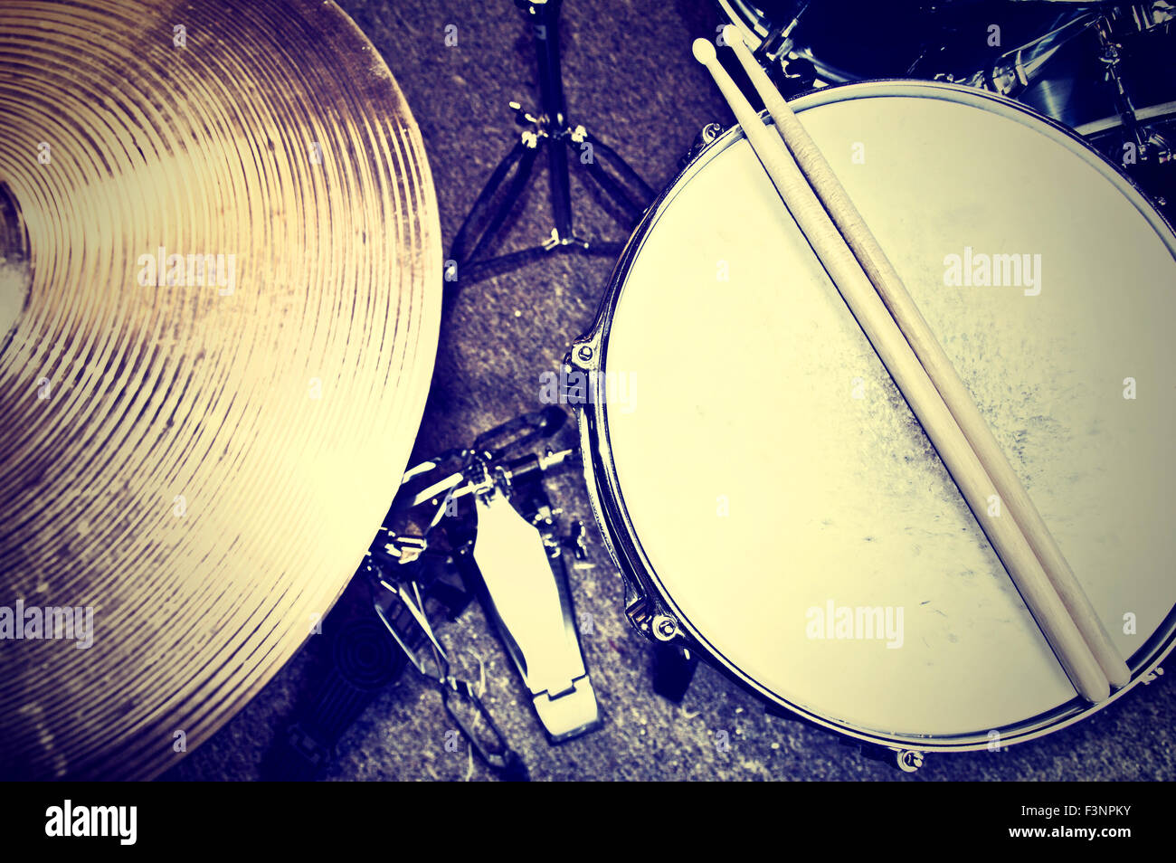 Drums conceptual image. Picture of drums and drumsticks lying on snare drum. Retro vintage