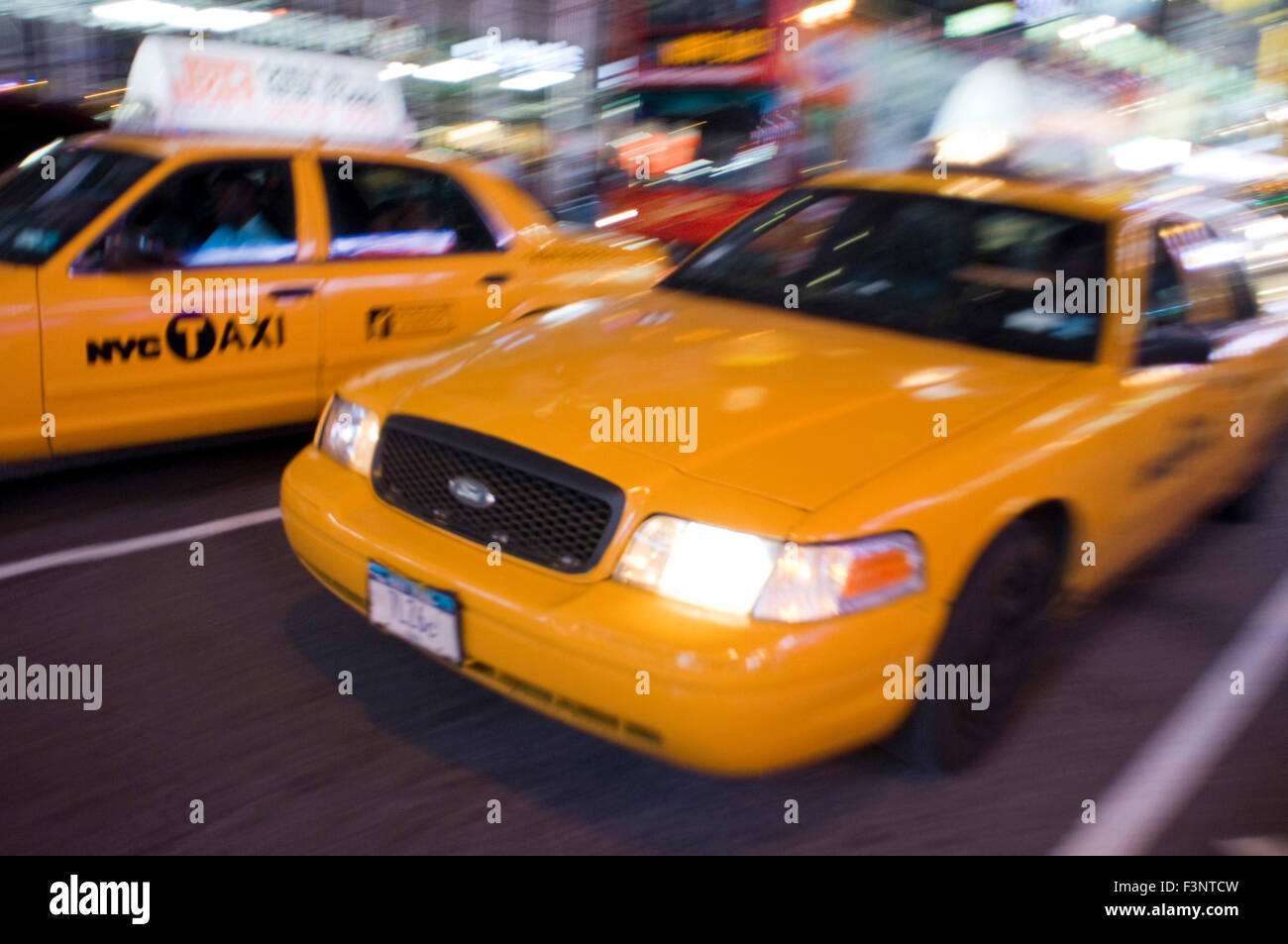 Countless yellow cabs each night travel Theater District area. The taxi (yellow cab) is, for sure, the means of transport most c Stock Photo