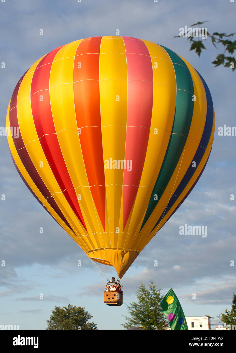 Hot air balloon lifting off early evening. Stock Photo