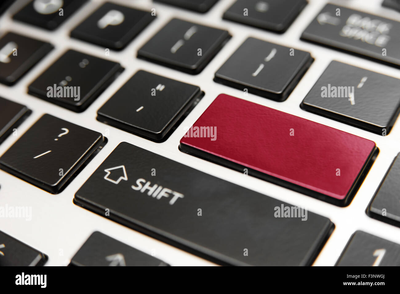 Laptop computer keyboard close-up with red blank enter key Stock Photo