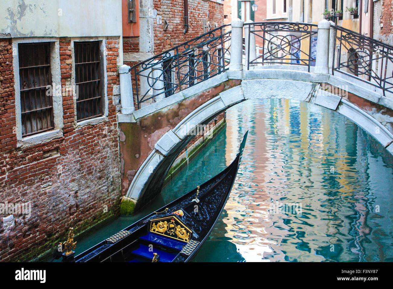 Gondola passing under a bridge in Venice, Italy Stock Photo