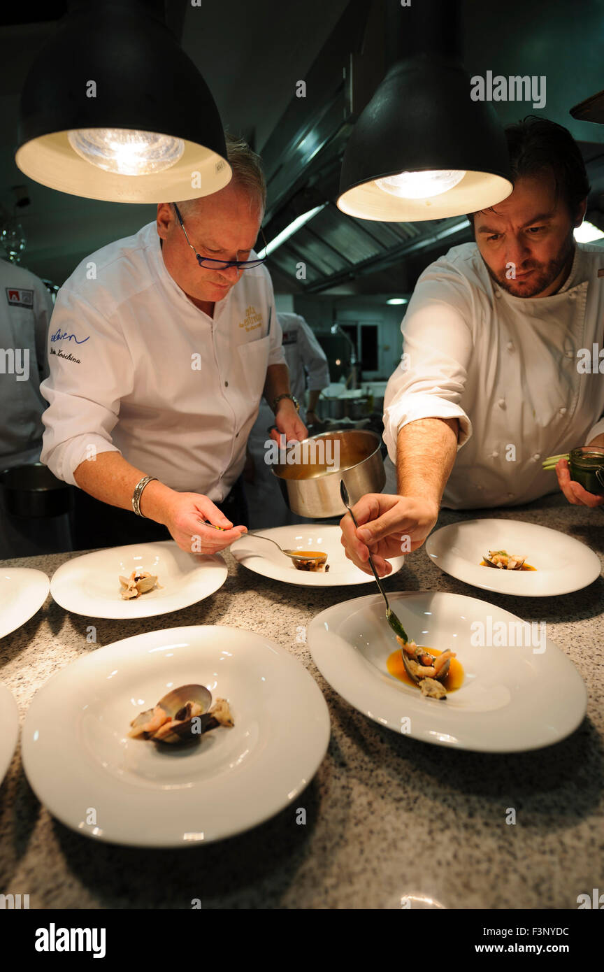 Chefs Dieter Koschina and Vitor Matos plating gourmet food Stock Photo