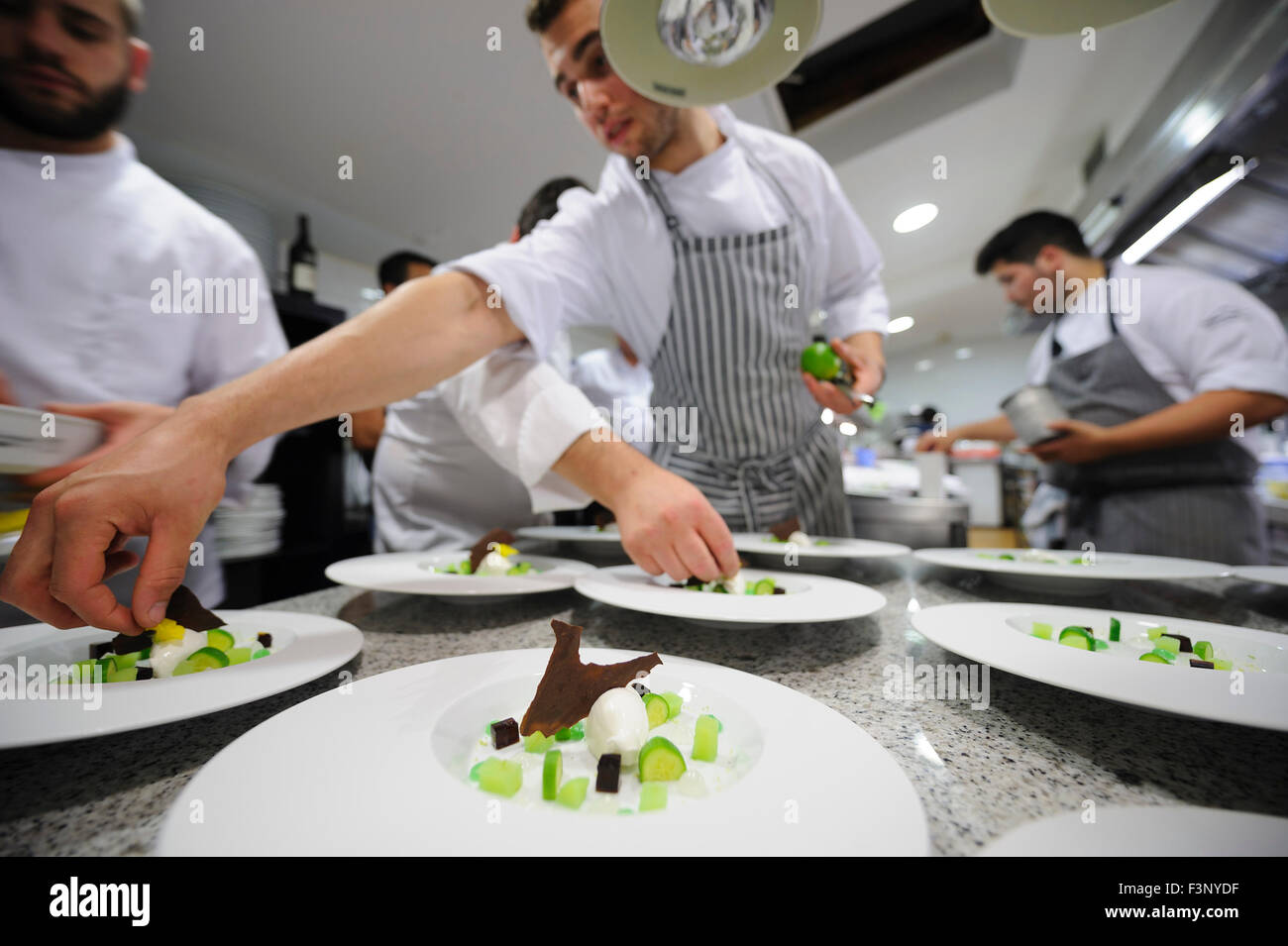 Young chefs plating gourmet food Stock Photo