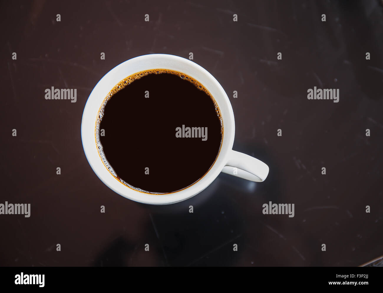 Cup of black coffee on a black table. Stock Photo