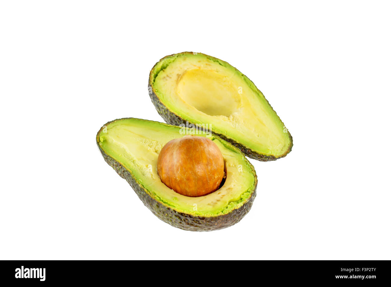 Two halves of avocado. Isolated on white background. Stock Photo