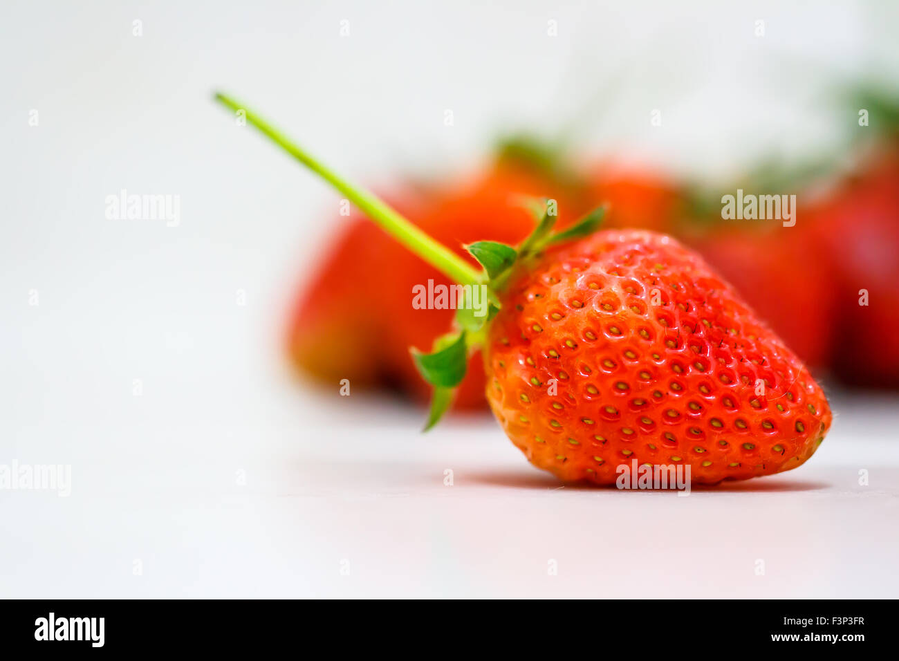 Strawberry berries on a white background Stock Photo - Alamy