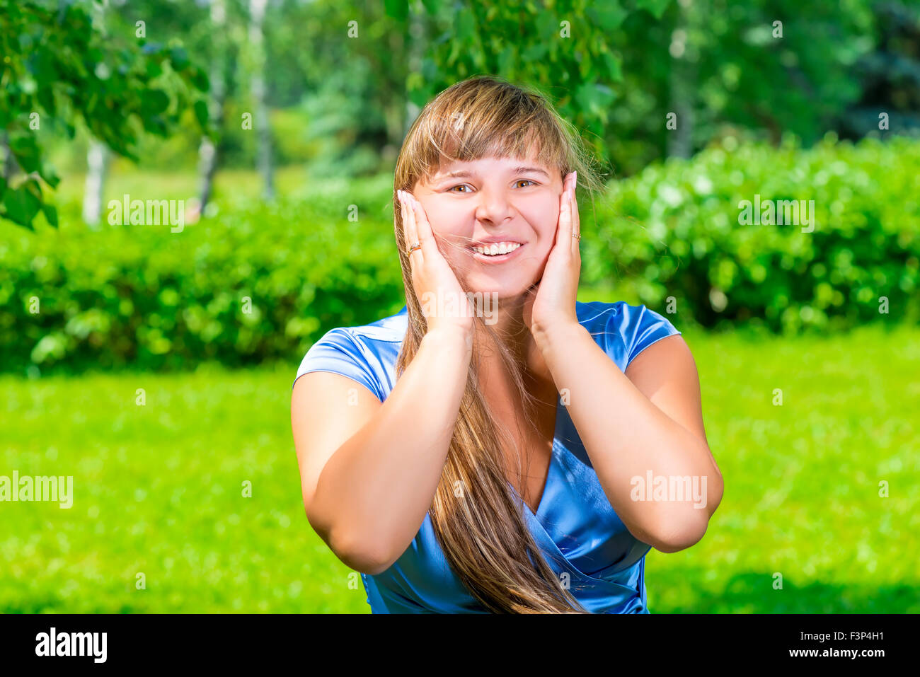 beautiful girl in a blue dress in the summer park Stock Photo - Alamy