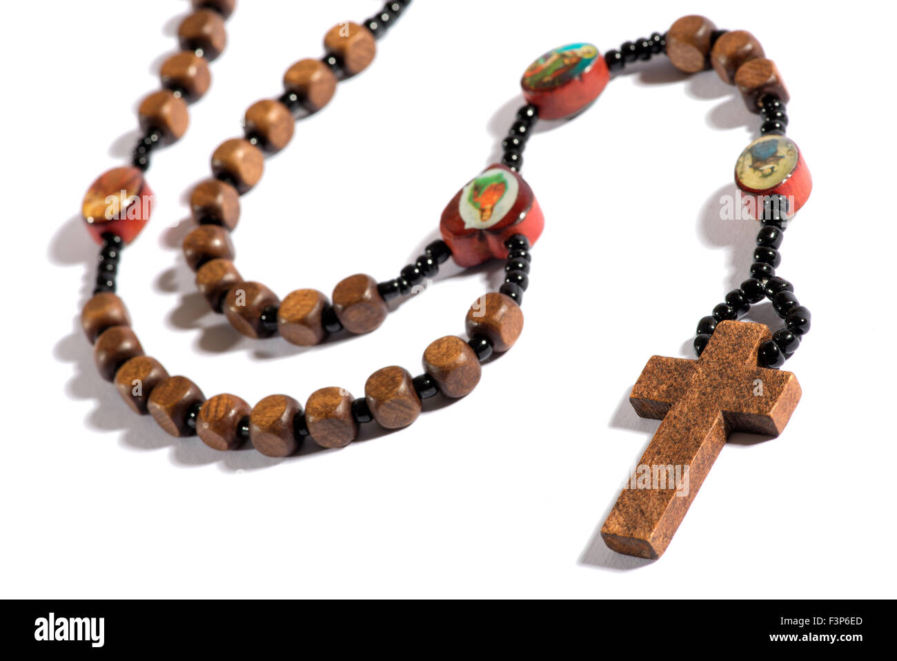 Roman Catholic rosary for counting off ones prayers on the beads during devotion on a white background with shadow, plain cross Stock Photo