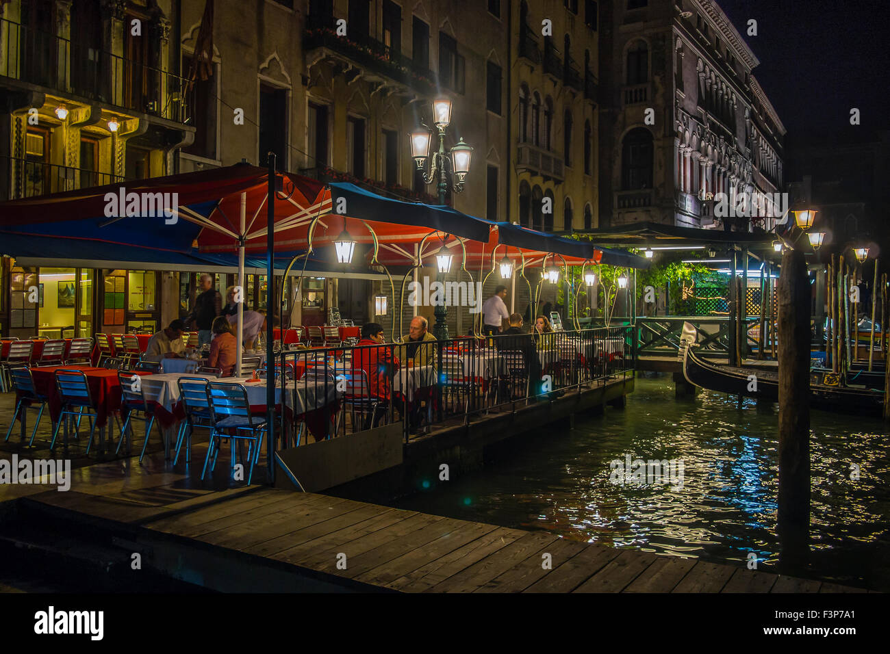 VENICE, ITALY - MAY 05, 2015: Restaurant Bar by the side of canal in Venice at night Stock Photo