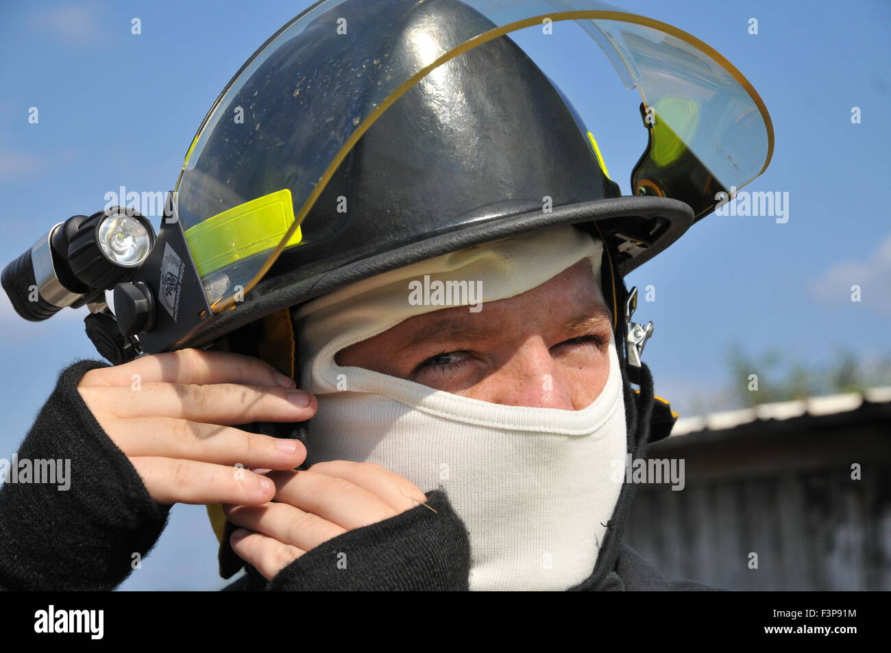 Portrait of a fire fighter in fire resistant clothes Stock Photo