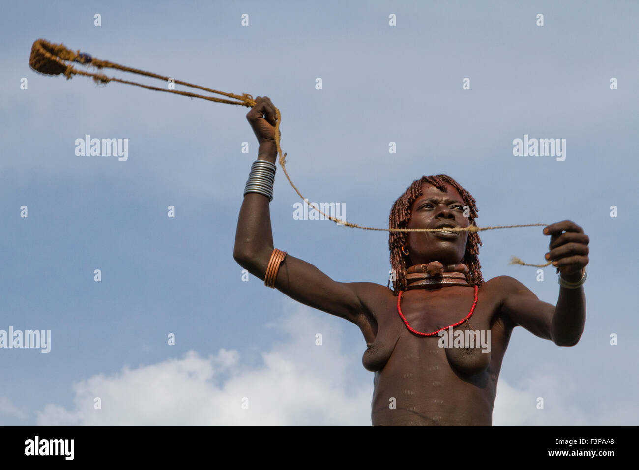 Africa, Ethiopia, Omo River Valley Hamer Tribe woman hunts with a slingshot Stock Photo
