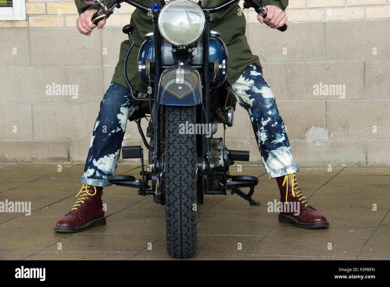 Scooter rider takes on a big bike Stock Photo - Alamy
