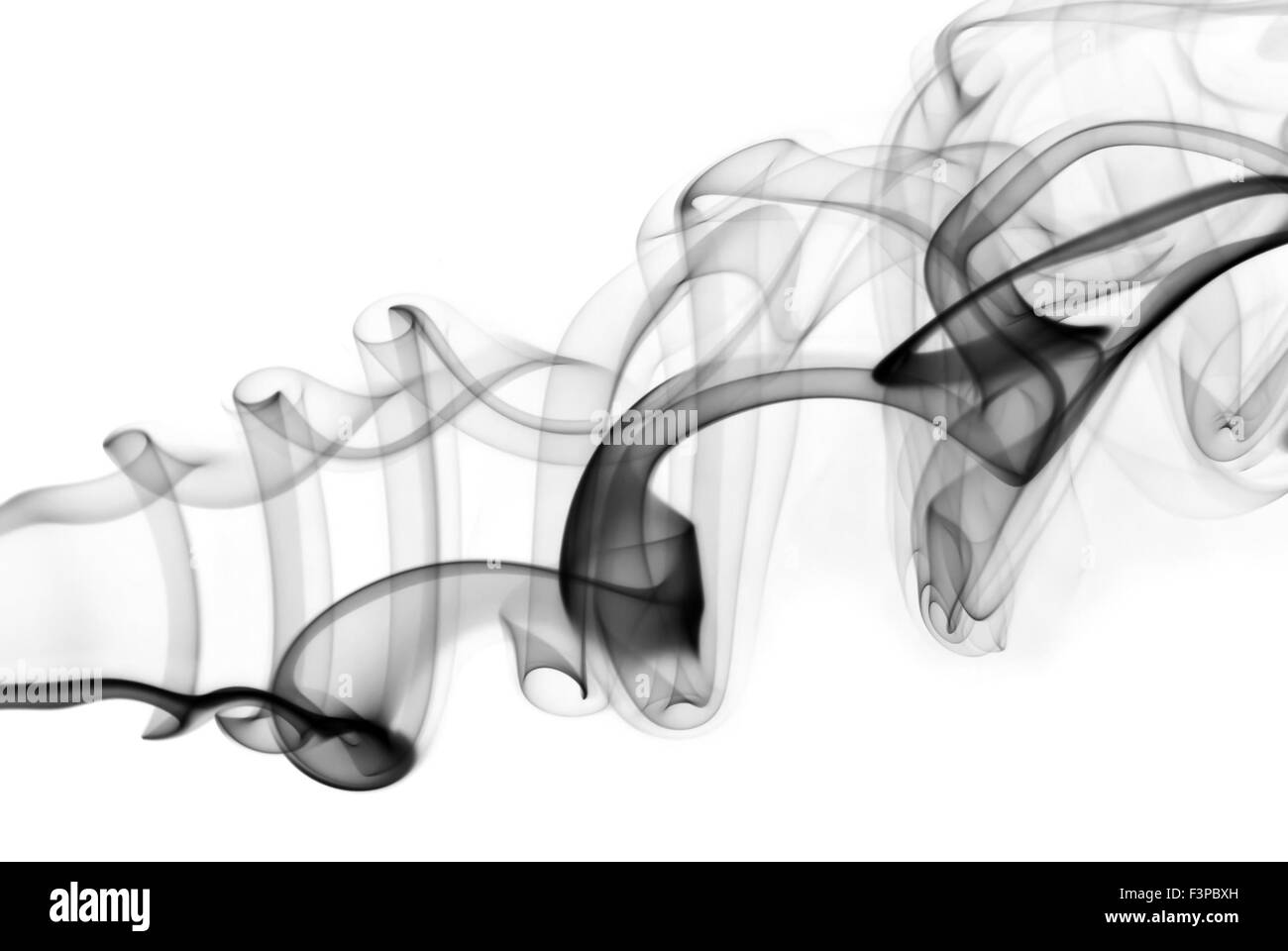 Photo of abstract smoke swirl on white background. Studio shot Stock