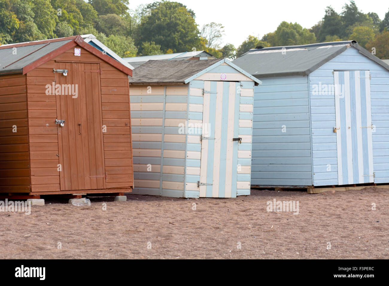 A line of wooden beach hut on the back beach in Teignmouth, Devon