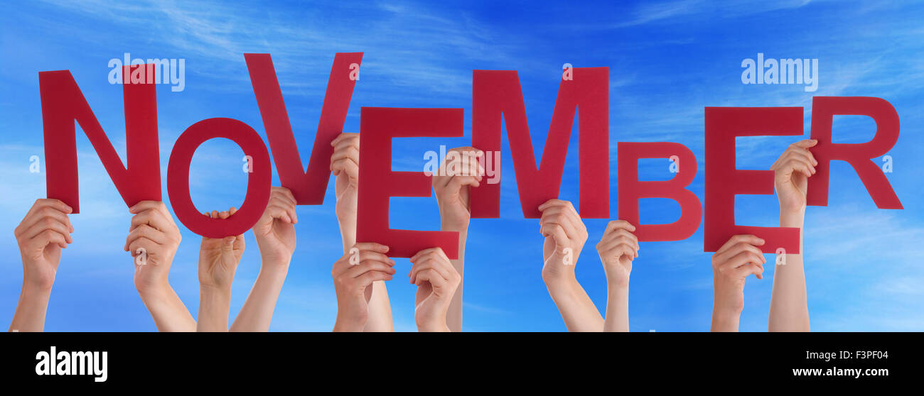 Many People Hands Holding Red Word November Blue Sky Stock Photo - Alamy