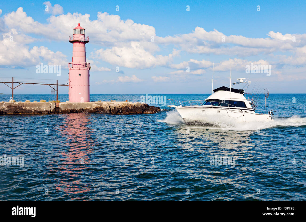 Boat by Algoma Pierhead Lighthouse - Alogma, Wisconsin, USA Stock Photo