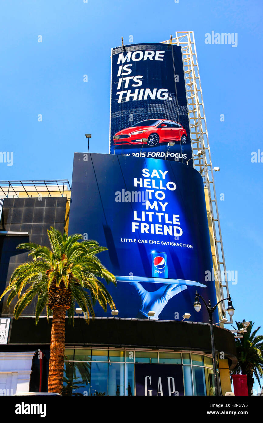 Huge advertising billboards above Hollywood Blvd in Los Angeles CA