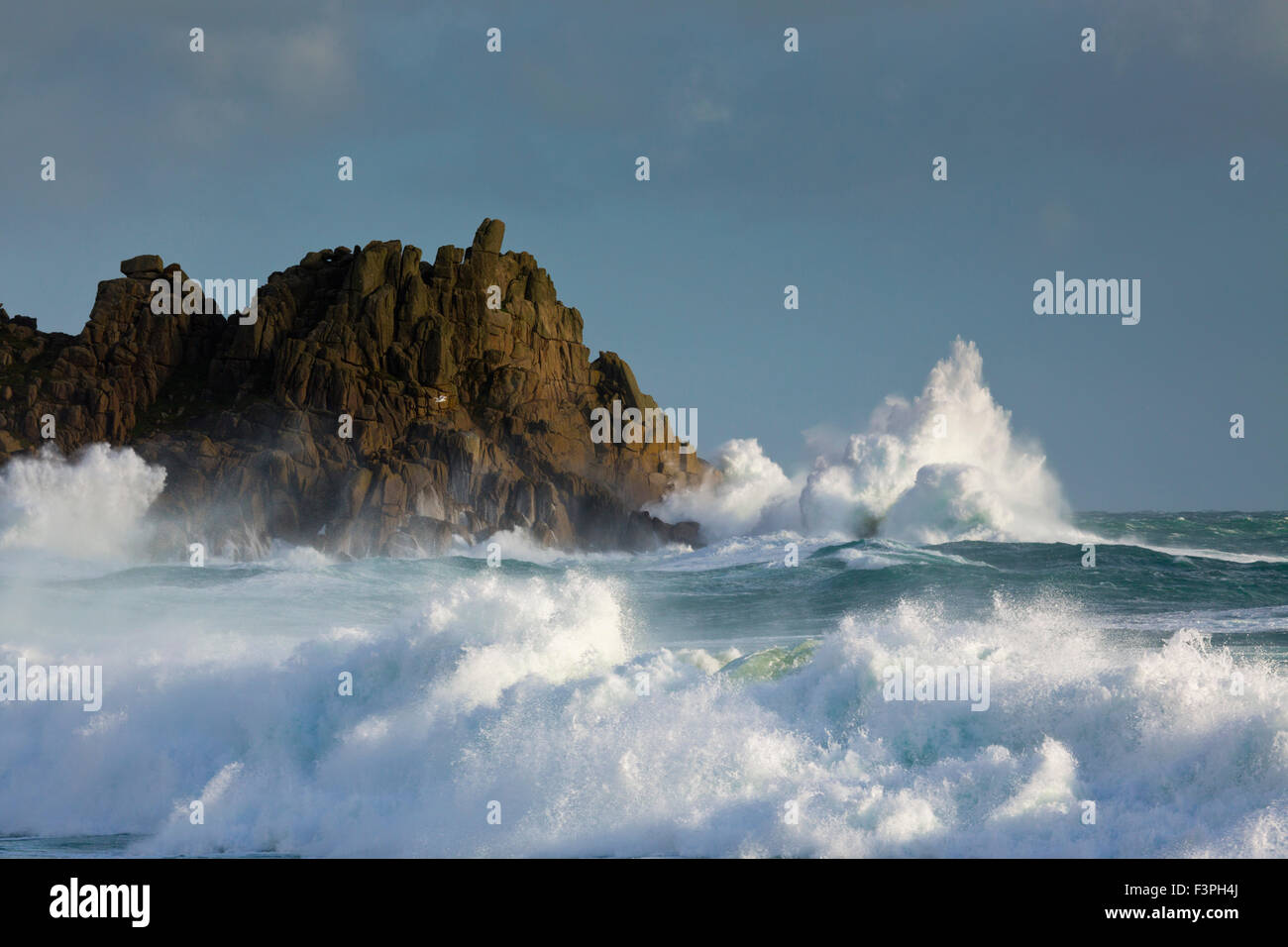 Porthcurno; Waves Breaking on Rocks Cornwall; UK Stock Photo