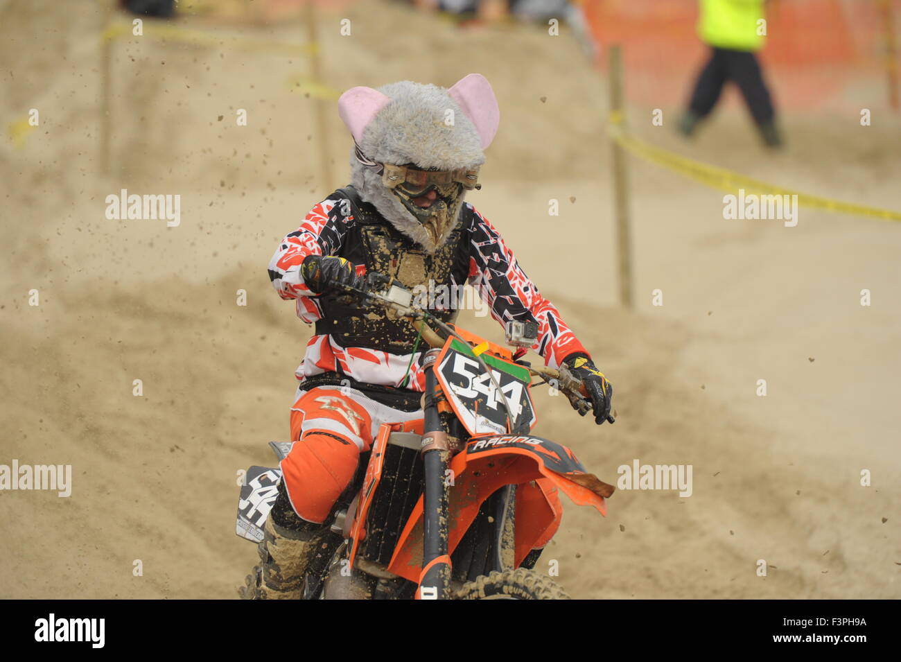 Weymouth, Dorset, UK - 11th October 2015. Annual Lion's Beach motocross weekend on Weymouth Beach.  Weymouth & Portland Lion's  jointly organise the popular event with Purbeck Motocross Club which attracts hundreds of riders, who test themselves on the tricky beach course - A rider who has added mouse ears to his helmet - Picture: Graham Hunt/Alamy Live News Stock Photo