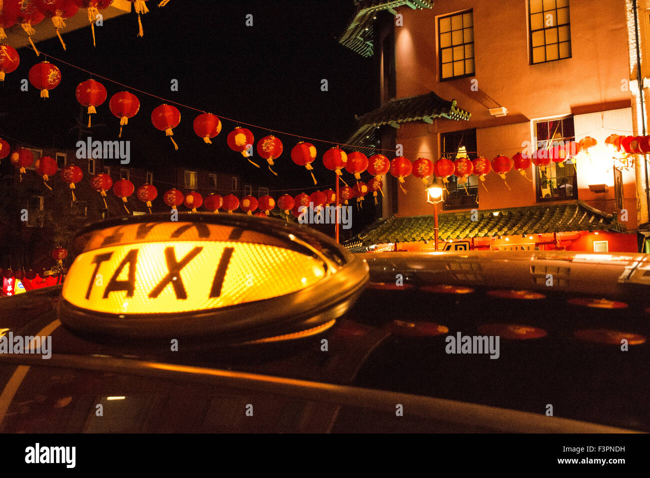 Black taxi cab sign in Chinatown, Soho, Central London, UK Stock Photo