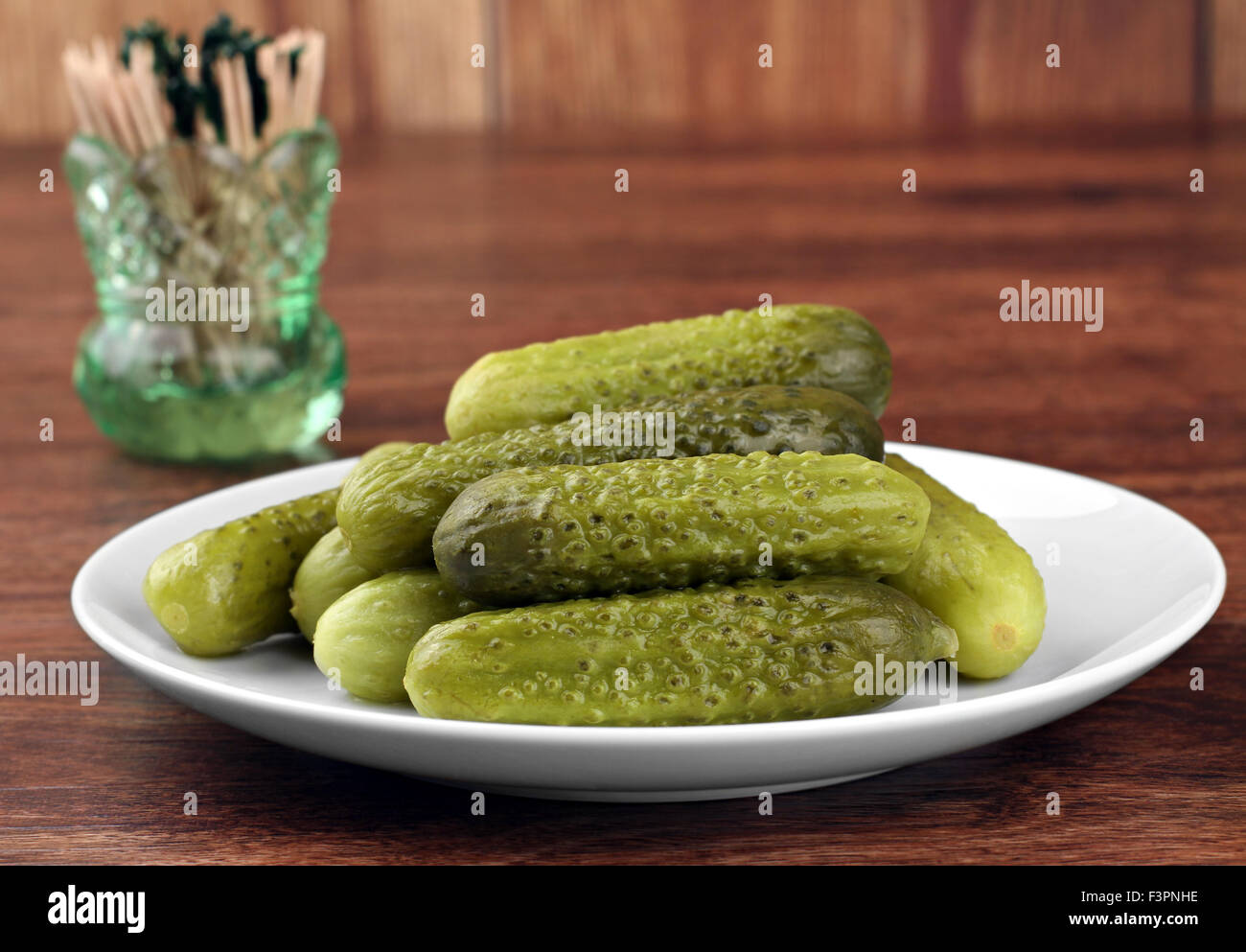 One plate of baby dill pickles, close up with copy space Stock Photo