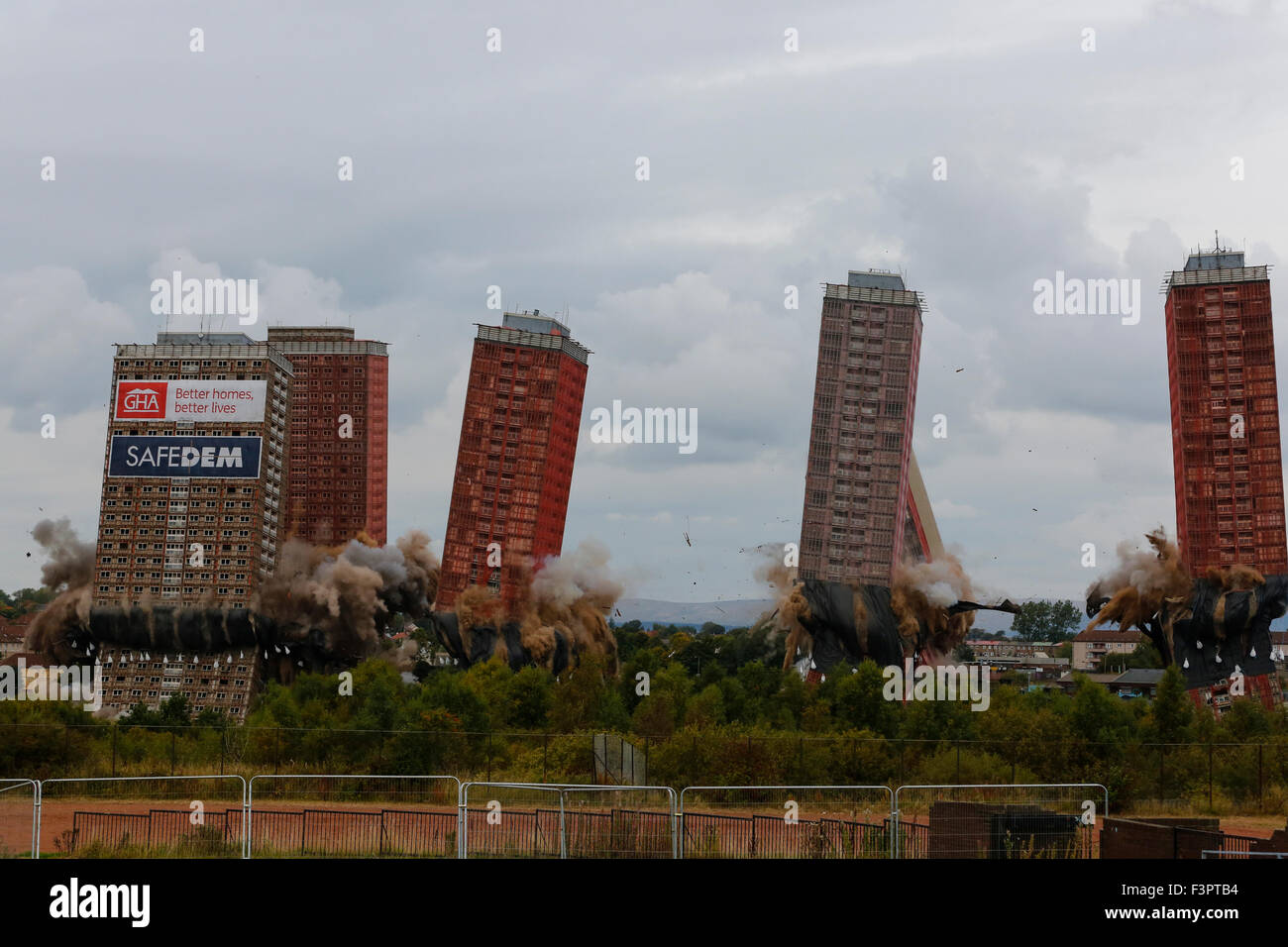 Glasgow, UK. 11th Oct, 2015. At 3.15pm on Sunday 11 October the Red Road Flats, Glasgow were brought down by controlled explosions. About 2500 local residents were  evacuated from the surrounding houses as a safety measure during the demolition. After the explosions it was obvious that only 4 of the housing blocks had fully collapsed and 2 remained partially demolished. It is planned to have the two towers demolished conventionally on Monday 12 October. It is estimated that over 10000 spectators watched the demolition. Credit:  Findlay/Alamy Live News Stock Photo