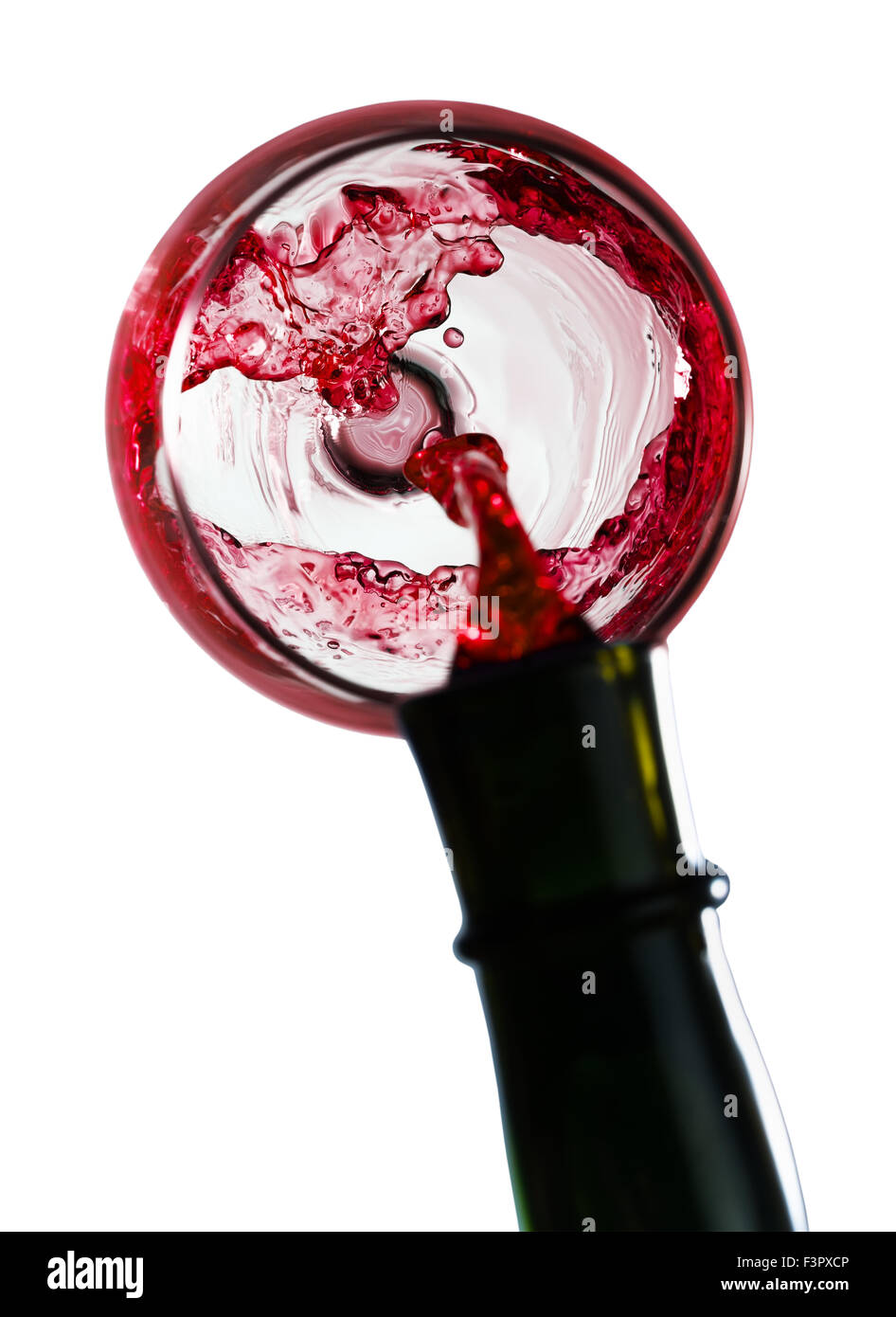 red wine pouring in glass isolated on white background. Stock Photo