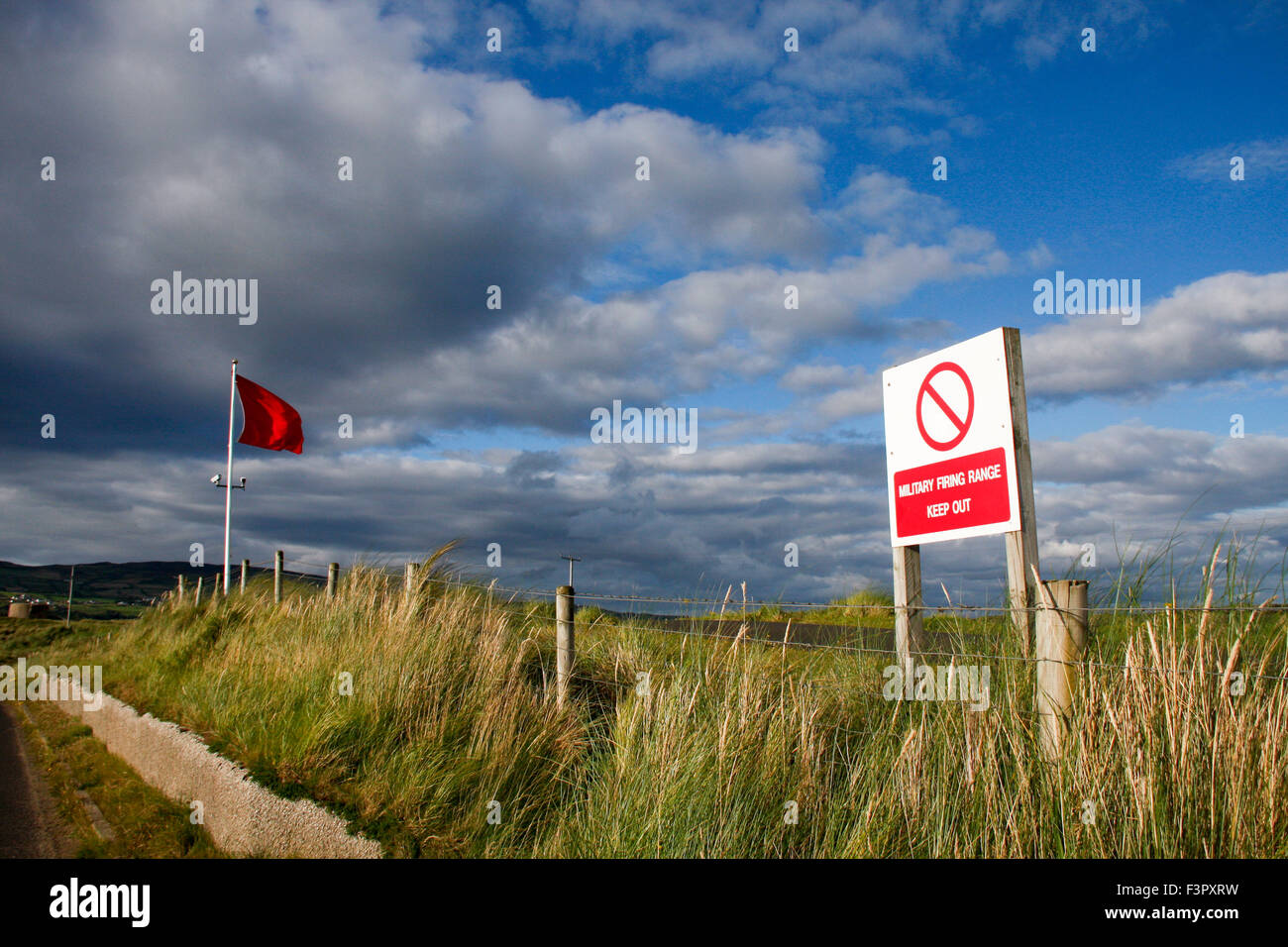 Keep out sign and red warning flag at military firing range, Magilligan Point, Northern Ireland Stock Photo