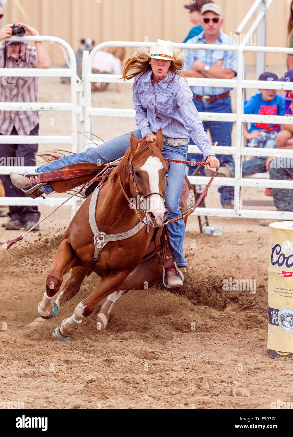 Rodeo cowgirl on horseback competing in barrel racing event, Chaffee