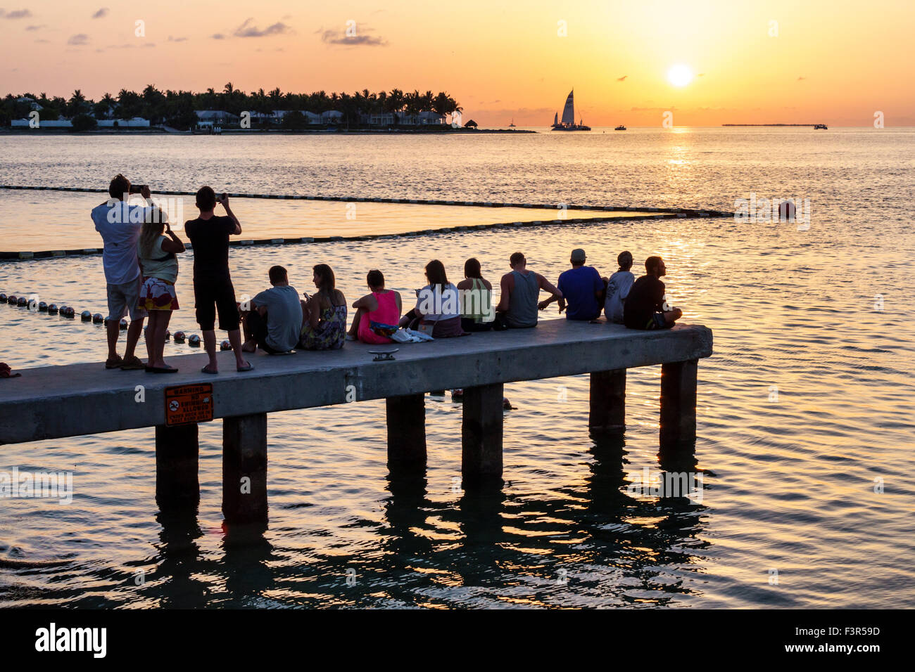 Key West Florida,Keys,pier,Gulf of Mexico,Sunset Island,setting sun,FL150509074 Stock Photo