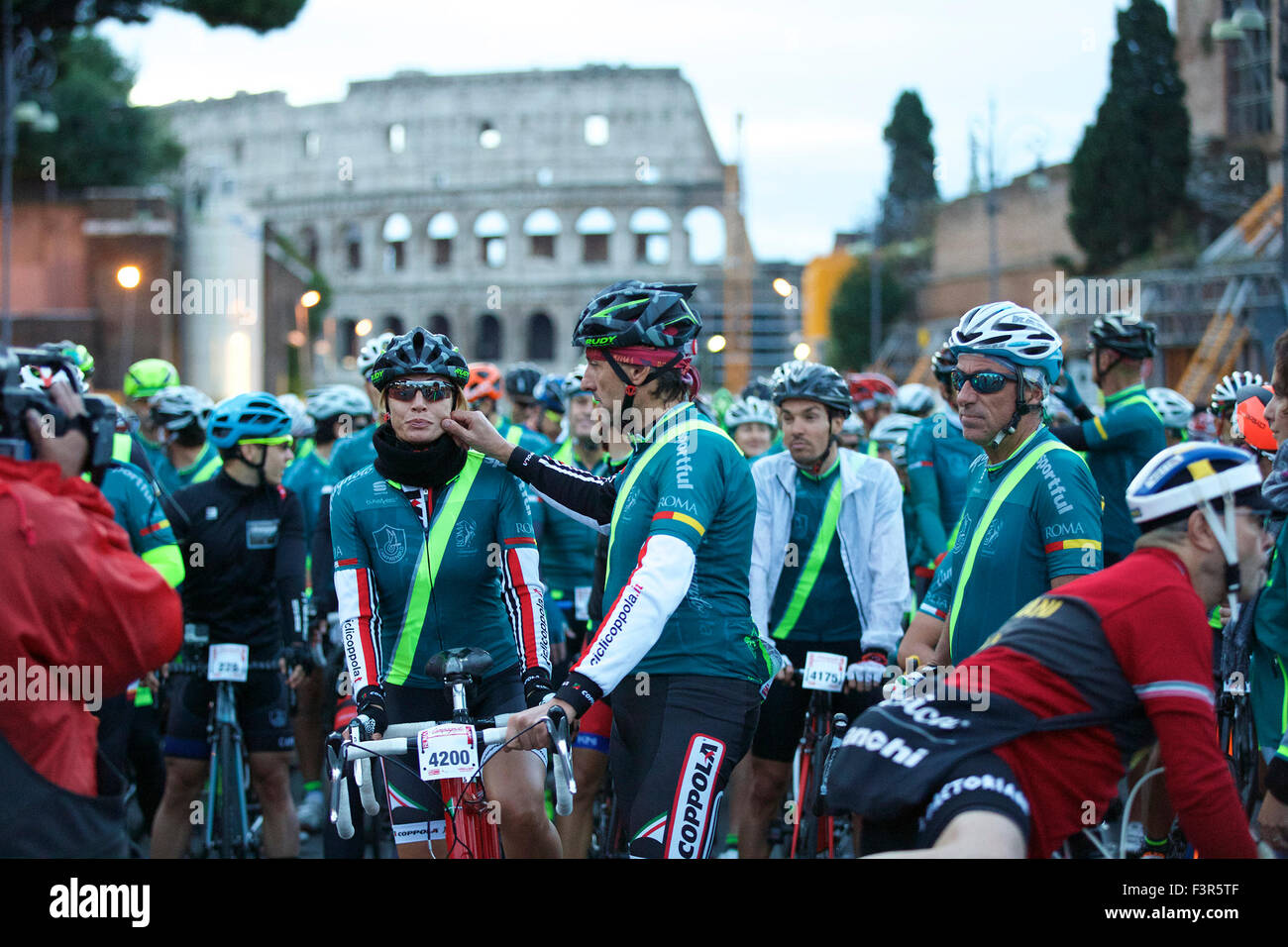 Rome, Italy. 11th Oct, 2015. Cyclists wait for the start of the historical cycling event 'Granfondo Campagnolo Rome' in Rome, Italy, on Oct. 11, 2015. The event attracted 5200 cyclists from 40 countries and regions. Cyclists started from the Colosseum, symbol of the Eternal City, cycling to historical spots in ancient Rome, Tiber River and Venice Square, and traveled out to the Roman hills. Finally, they rode past the cobblestones of ancient Appian Way to cross the finishing line. Credit:  Jin Yu/Xinhua/Alamy Live News Stock Photo