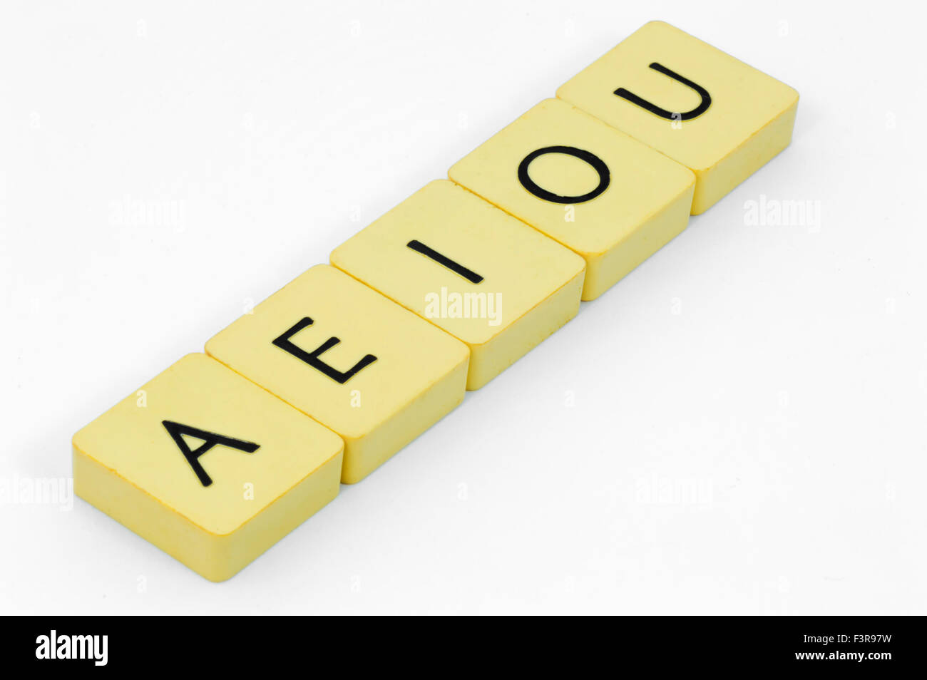 Yellow vowels cube with white background Stock Photo