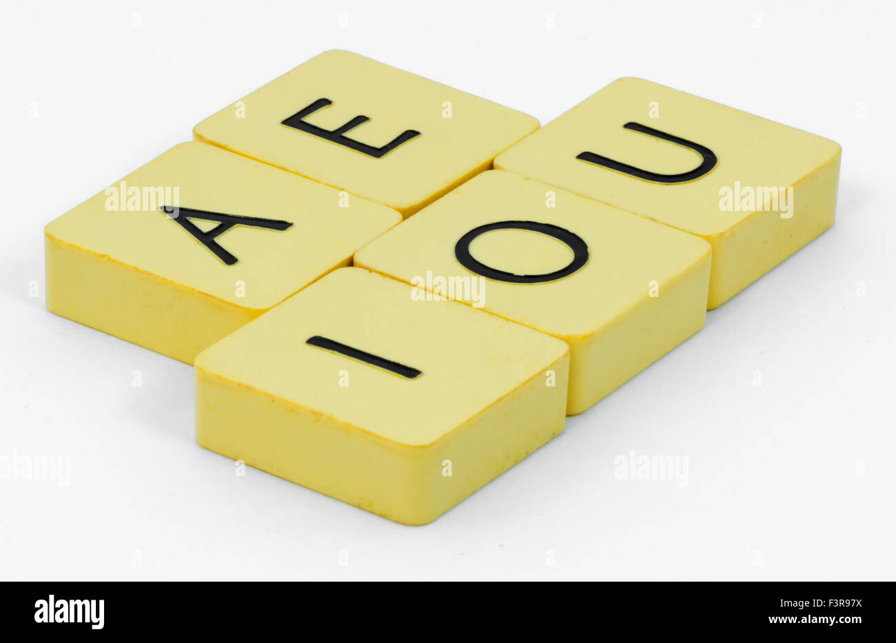 Yellow vowels cube with white background Stock Photo - Alamy
