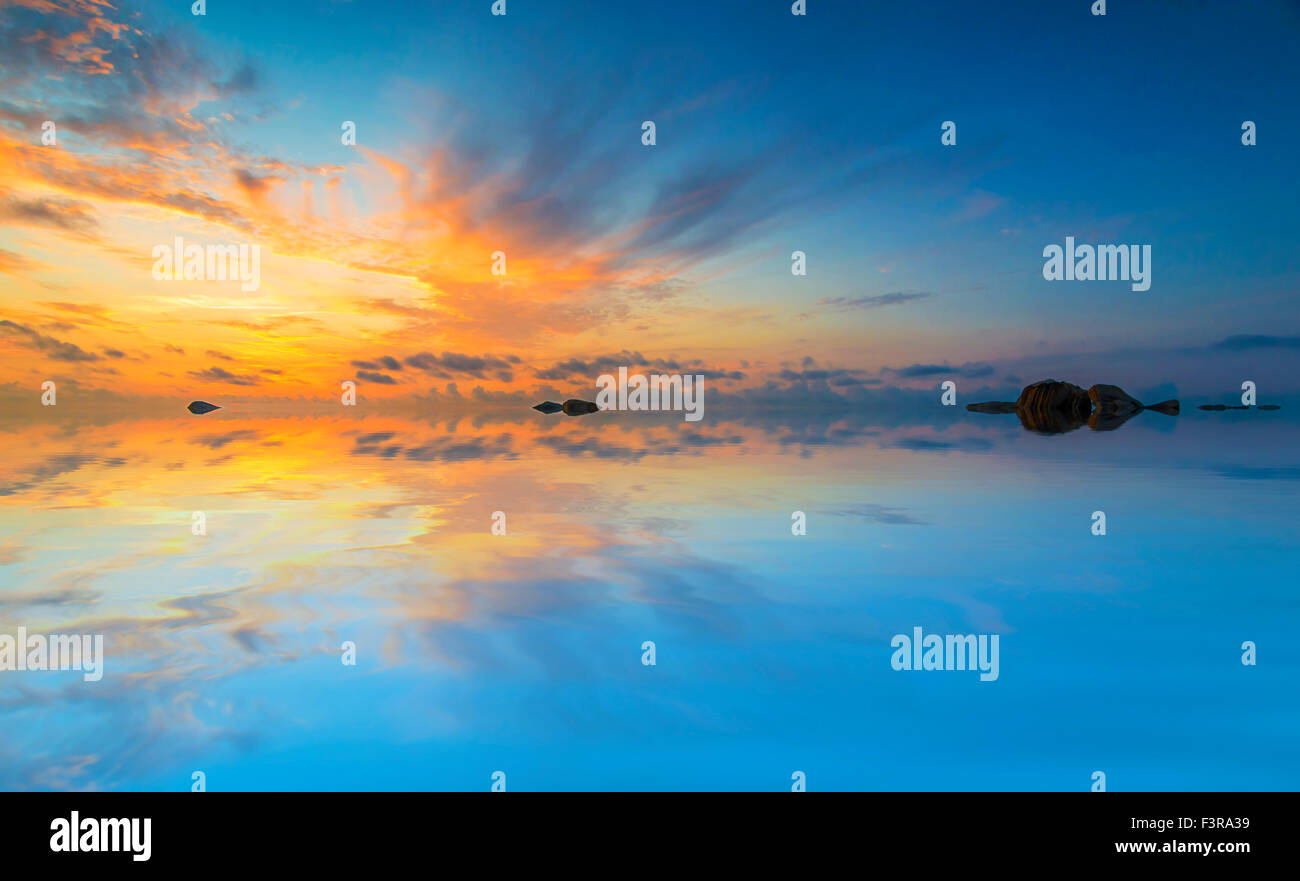Beach with sunrise background Stock Photo - Alamy