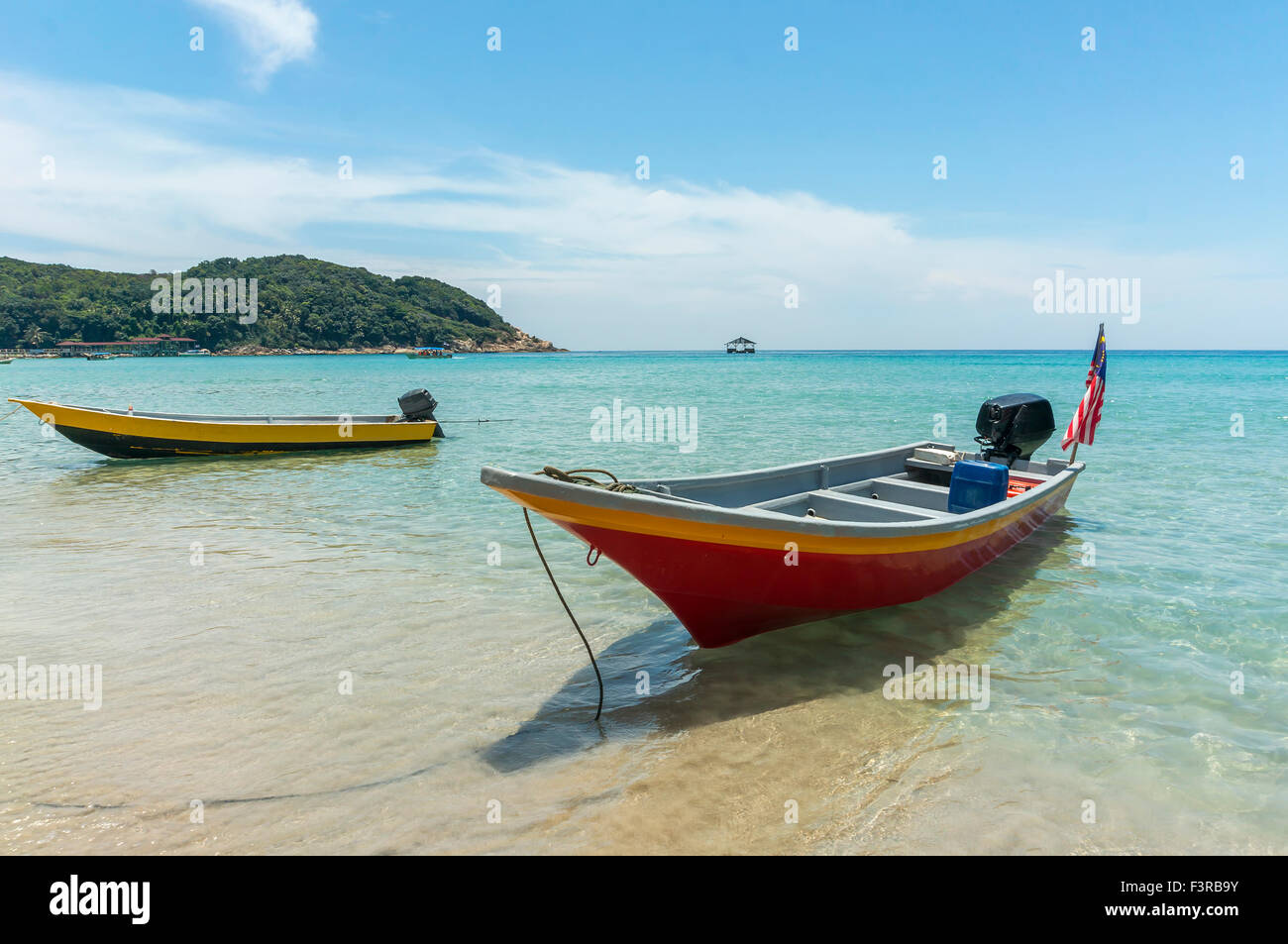 Boats with clear water and blue skies at Perhentian Island, Malaysia ...