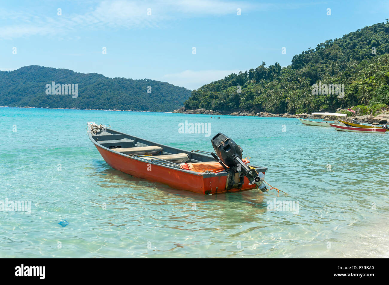 Boats with clear water and blue skies at Perhentian Island, Malaysia ...