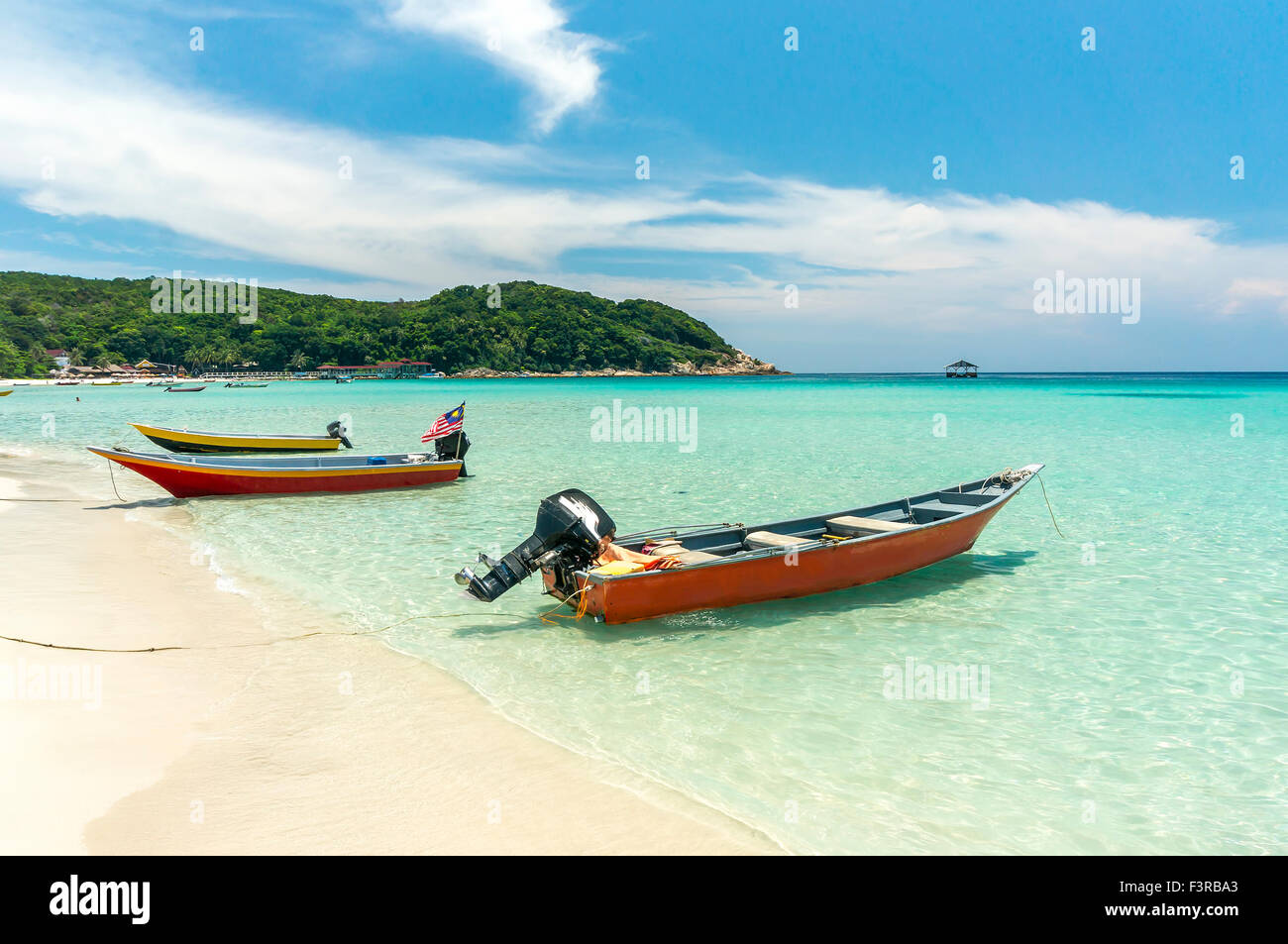 Boats with clear water and blue skies at Perhentian Island, Malaysia ...