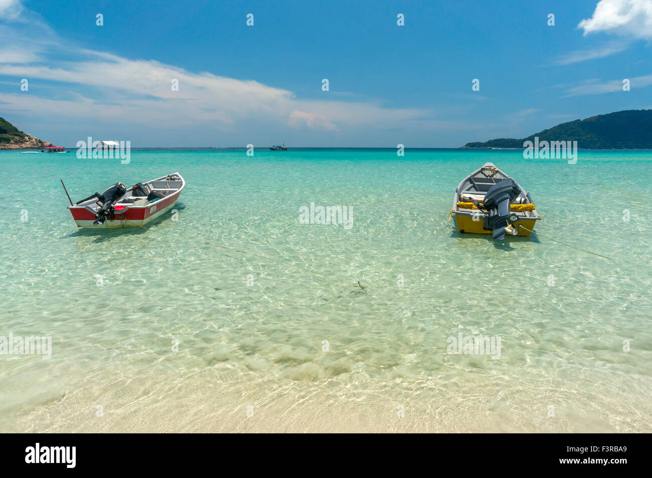 Boats with clear water and blue skies at Perhentian Island, Malaysia ...