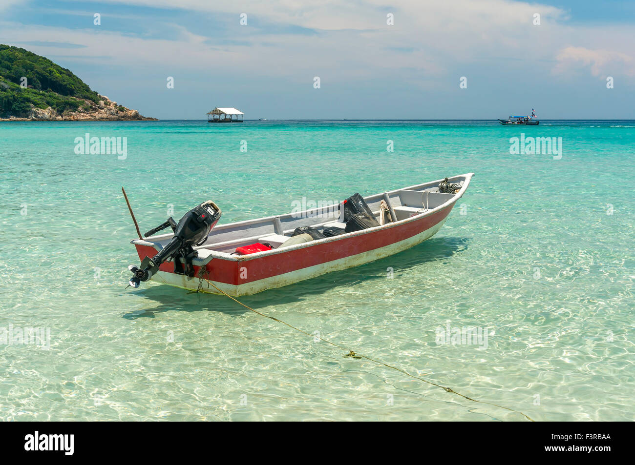 Boat with clear water and blue skies at Perhentian Island, Malaysia ...