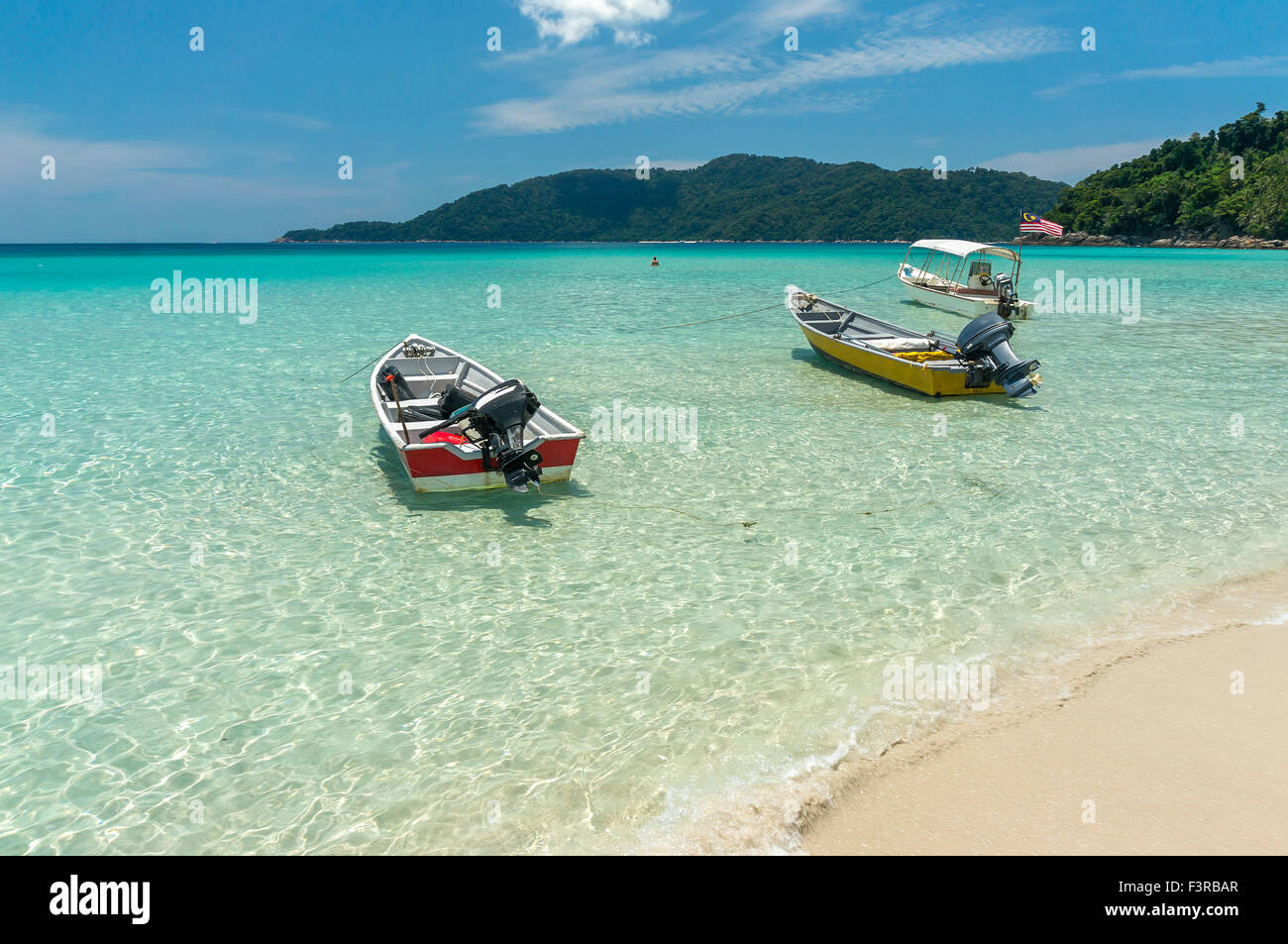Boats with clear water and blue skies at Perhentian Island, Malaysia ...