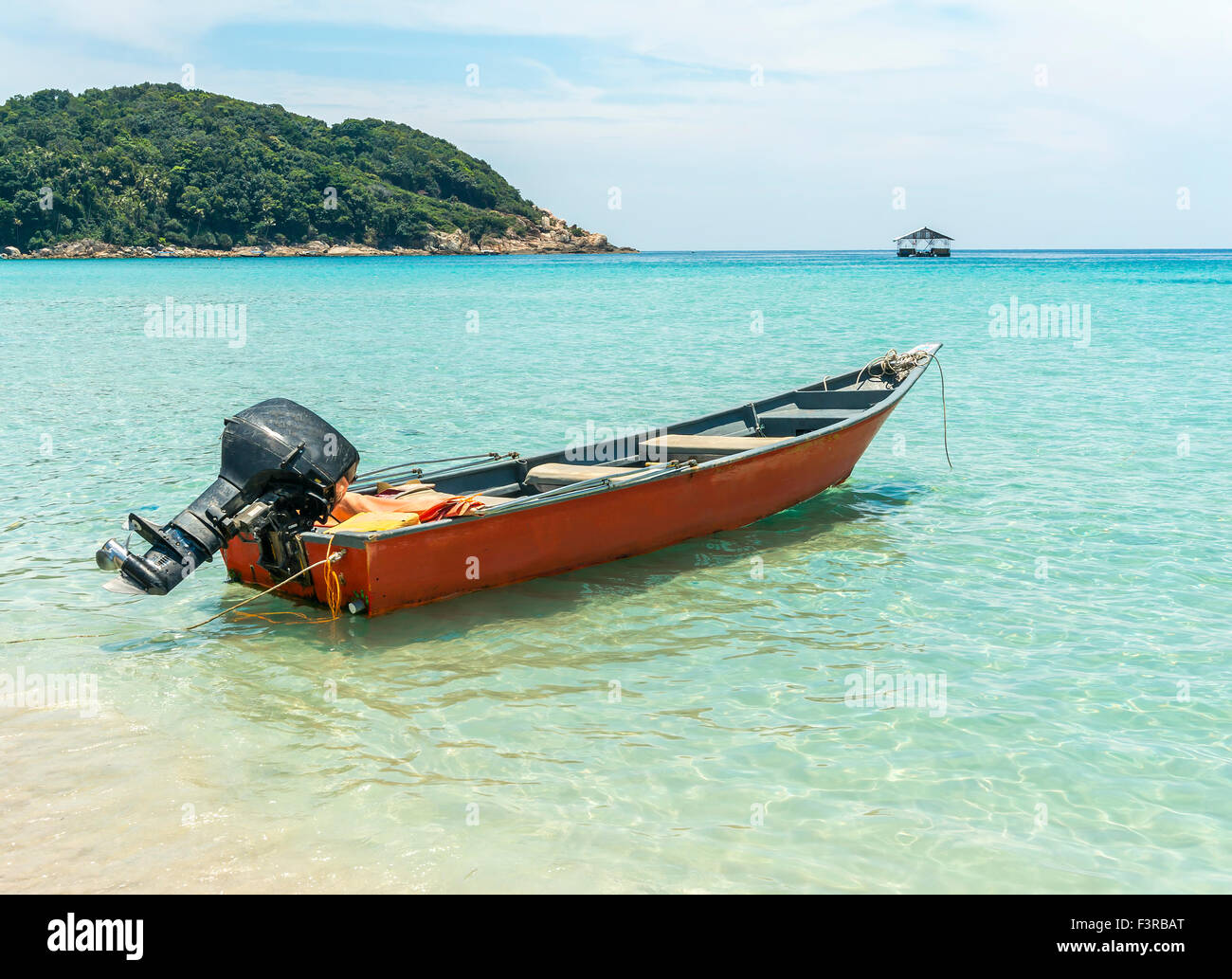 Boat with clear water and blue skies at Perhentian Island, Malaysia ...