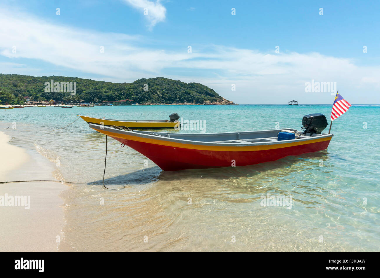 Boats with clear water and blue skies at Perhentian Island, Malaysia ...