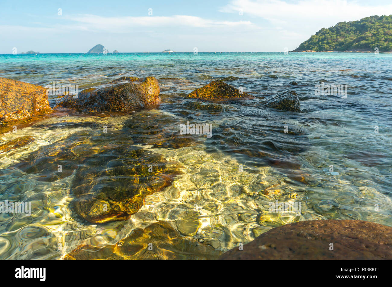 Beach rock with clear water Stock Photo - Alamy