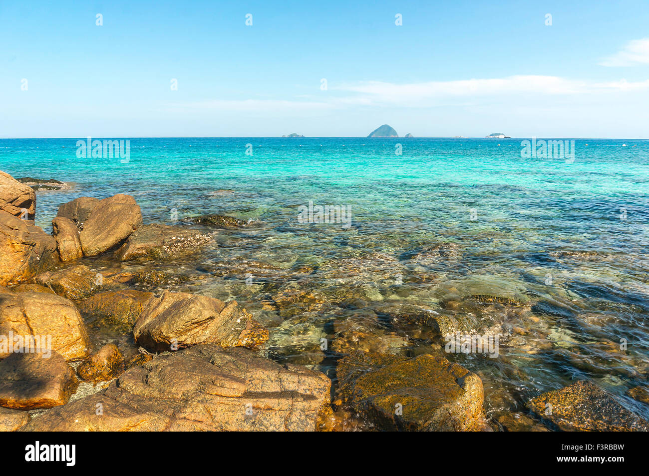 Beach rock with clear water Stock Photo - Alamy
